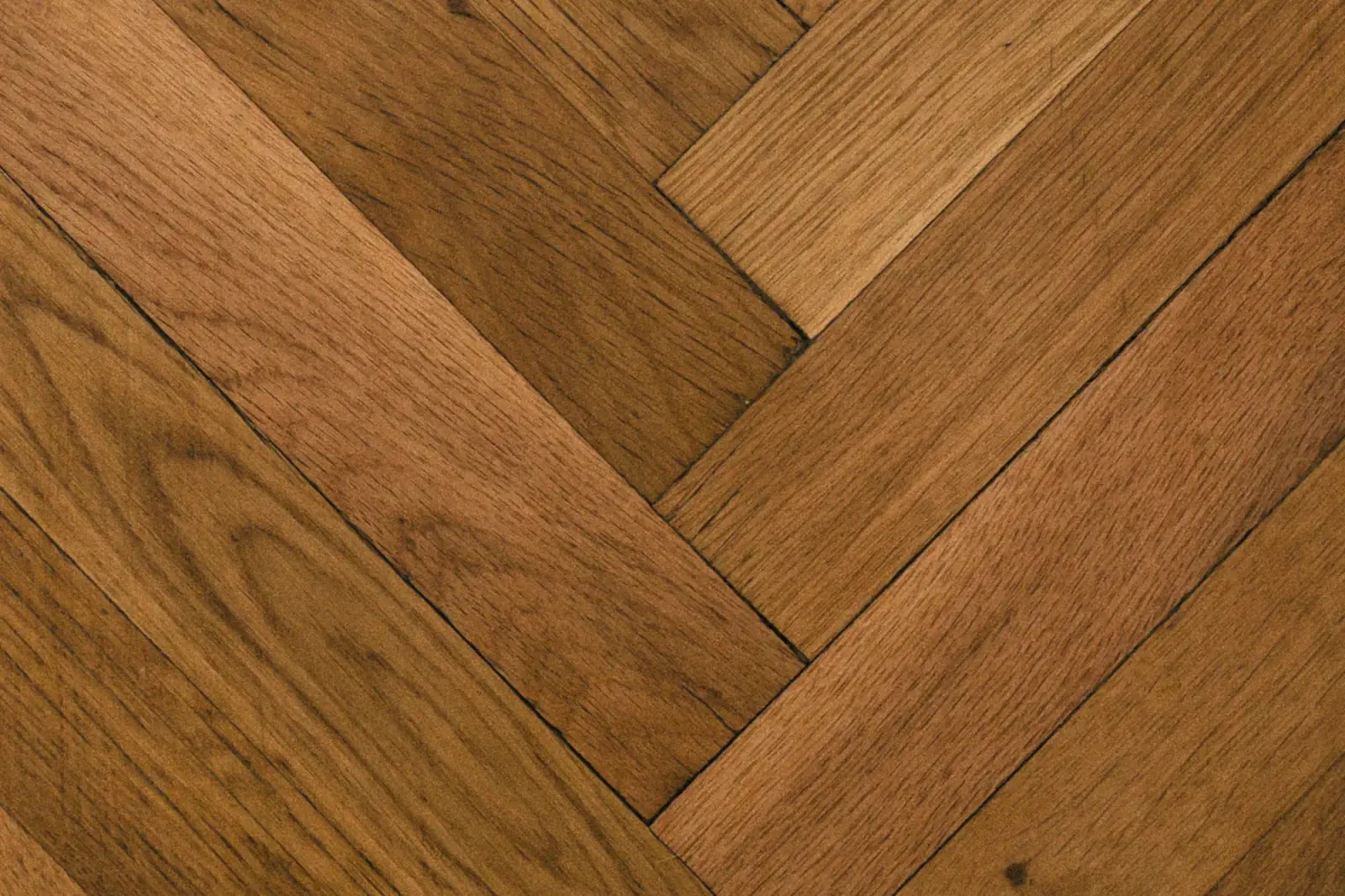 Close-up of oak herringbone blocks, each block meeting its neighbour at a right angle
