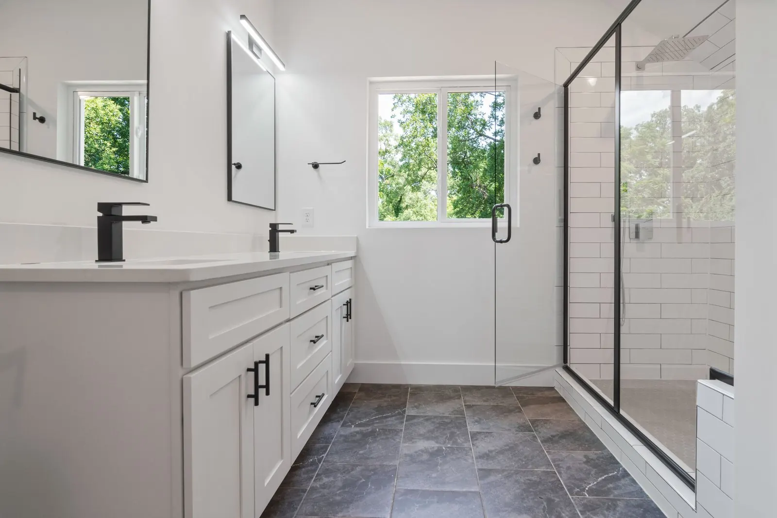 Bathroom with dark slate-look rectangular floor tiles laid in a half bond