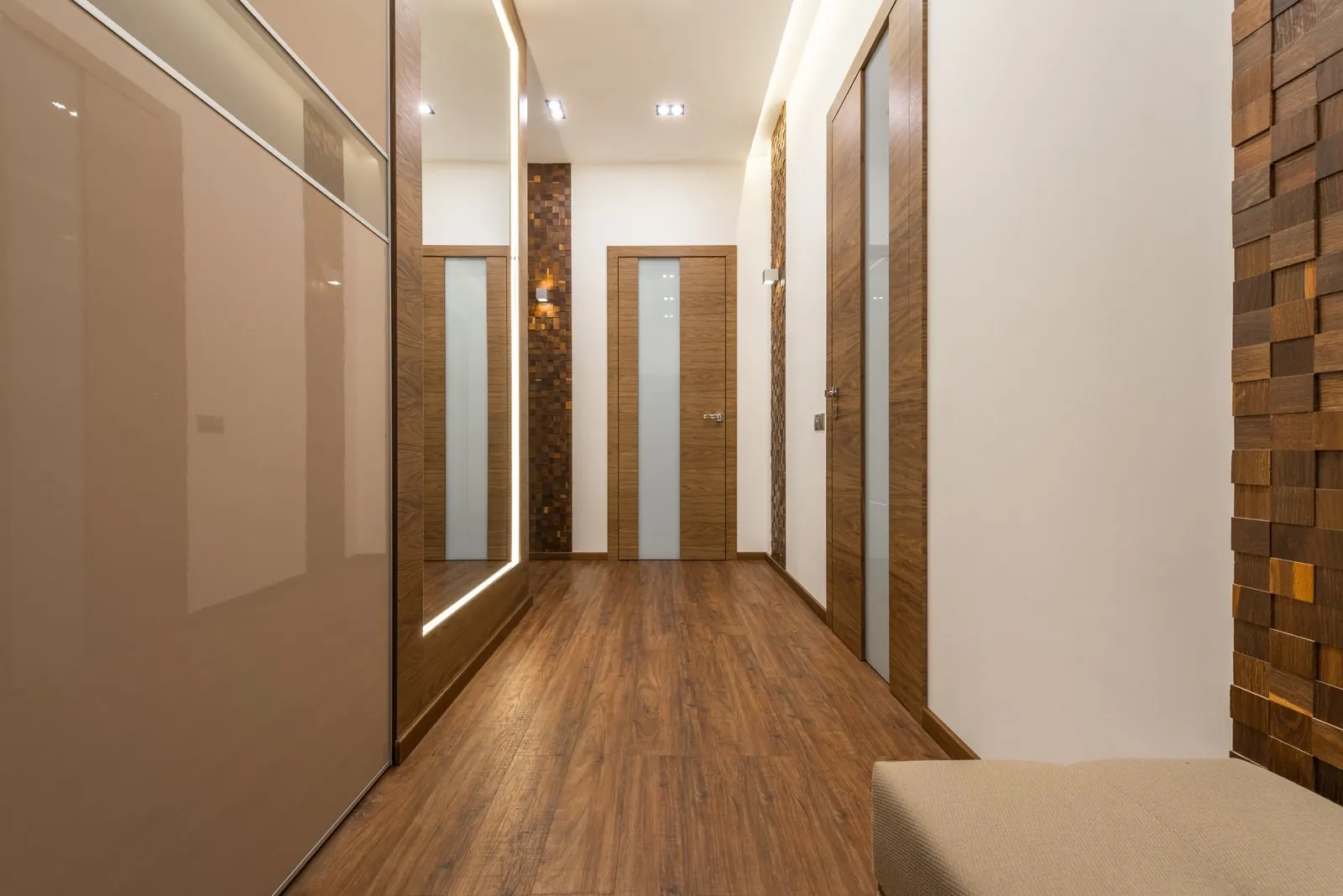 Narrow hallway with brown wood-look laminate along its length