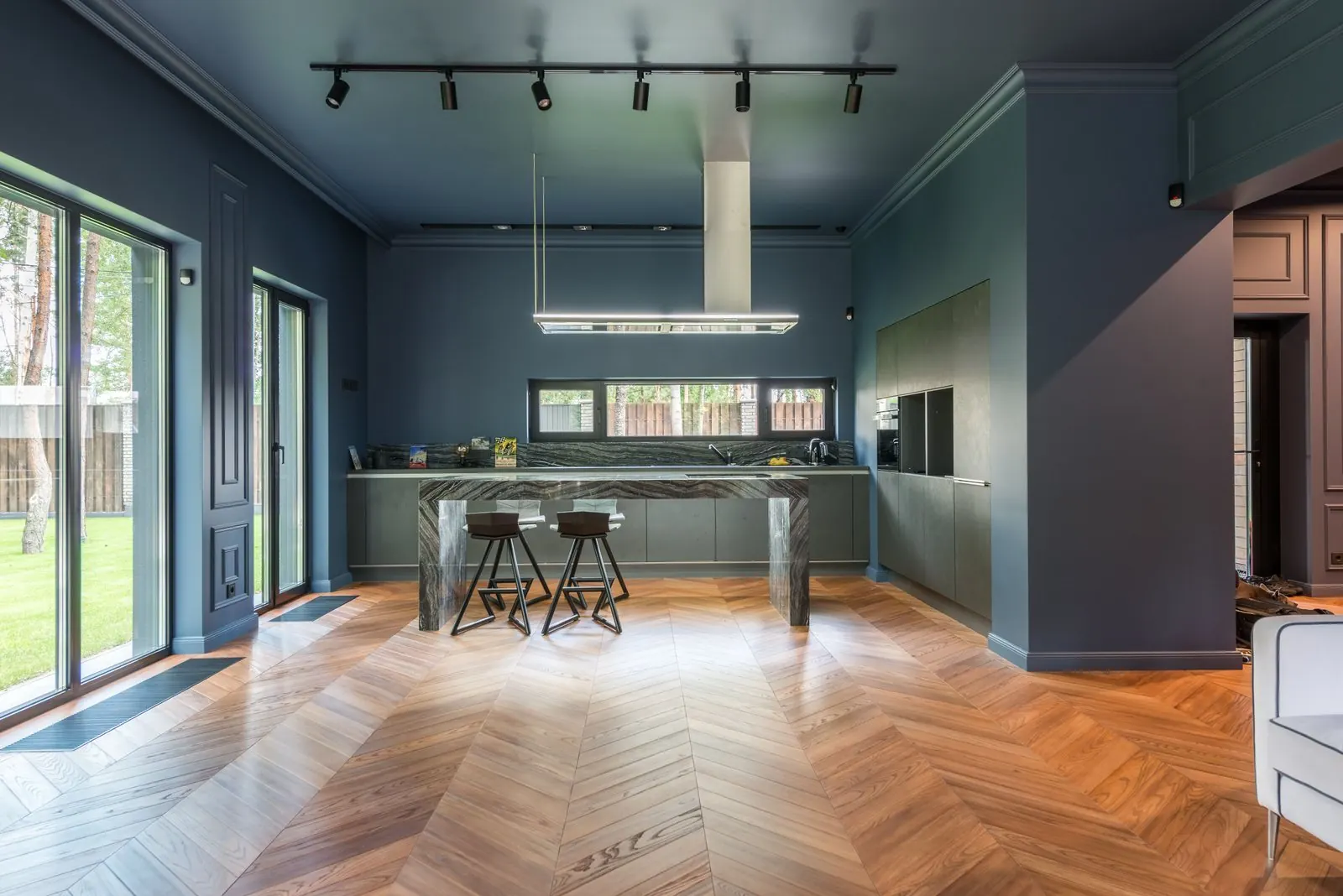 Kitchen and dining space with a wood-look chevron floor