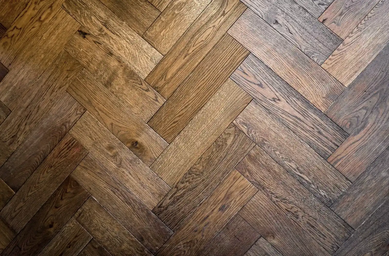 Top-down view of an oak floor laid in a herringbone pattern